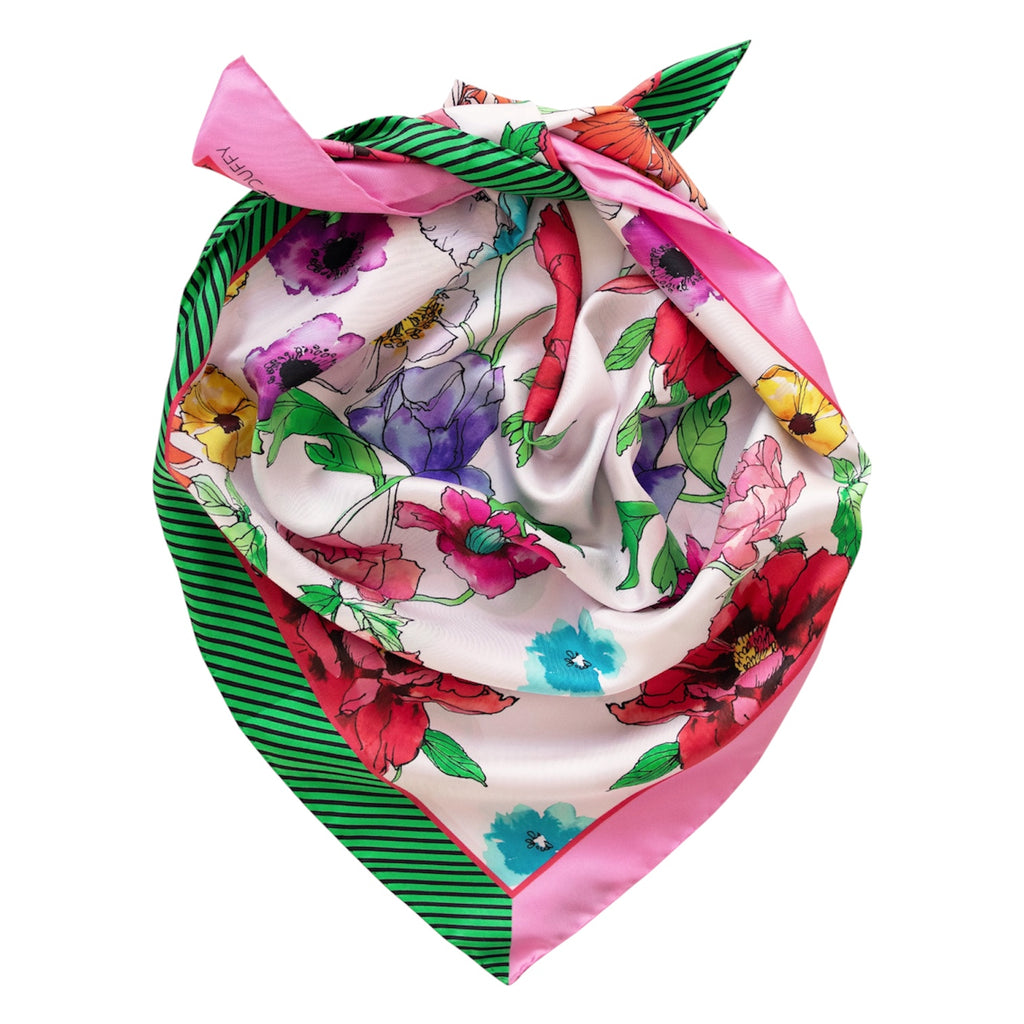 Colourful floral headscarf with a green and pink ribbon on a white background