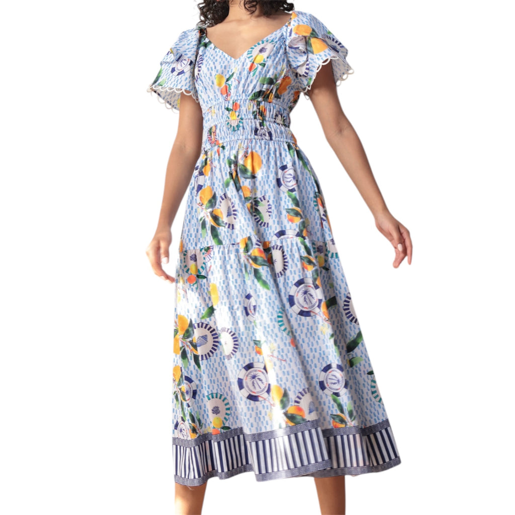 Colourful dress with nautical and fruit pattern and striped trim by Emily Lovelock