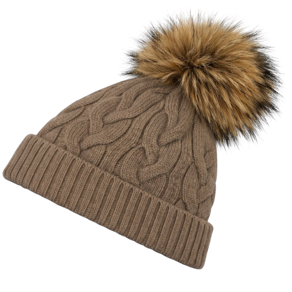 Side view of taupe cable knit cashmere beanie with detachable raccoon fur pom pom