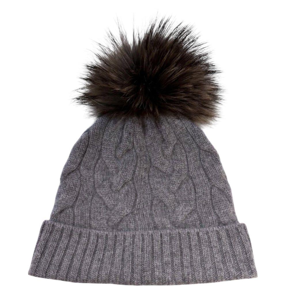Grey cable knit cashmere beanie with detachable raccoon fur pom pom by Kenmare Cashmere